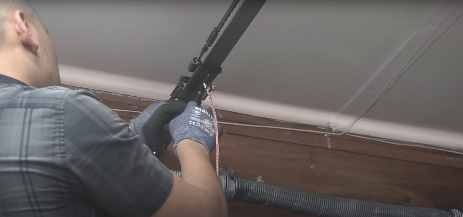 A certified technician from Element Garage Doors Repair LLC performing a safe and professional repair on a garage door spring